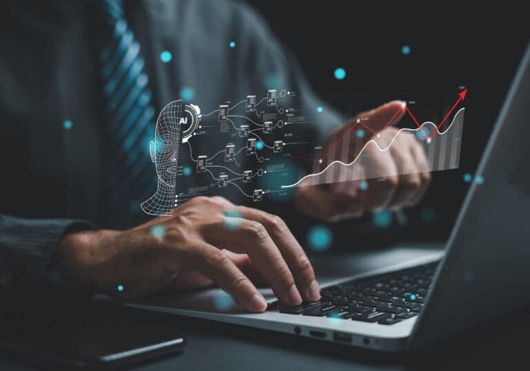 Digital marketer typing on a laptop with holographic AI wireframe face, workflow diagram, and an ascending growth line chart.